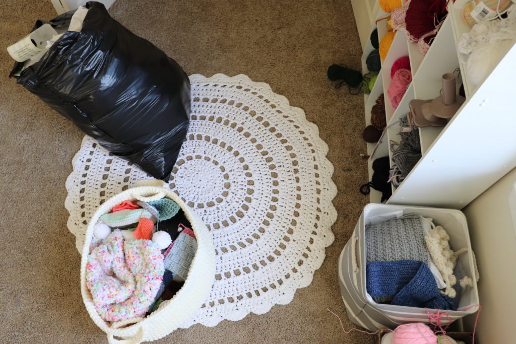 A photo of Sigoni using trash bags and baskets to sort through and organize her yarn stash - via Sigoni Macaroni's latest post, Spring Clean Your Yarn Stash and Get Organized in 5 Easy Steps