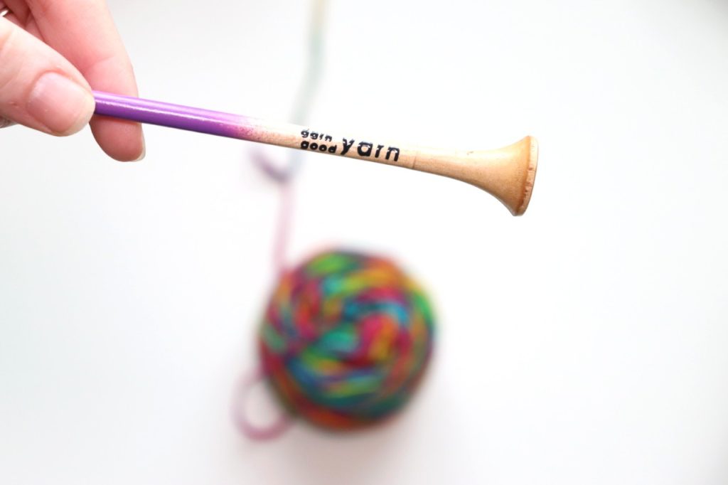 The crochet hook inside of the Darn Good Yarn of the Month Subscription Box is a 5mm crochet hook, dip-dyed purple, and handmade in India