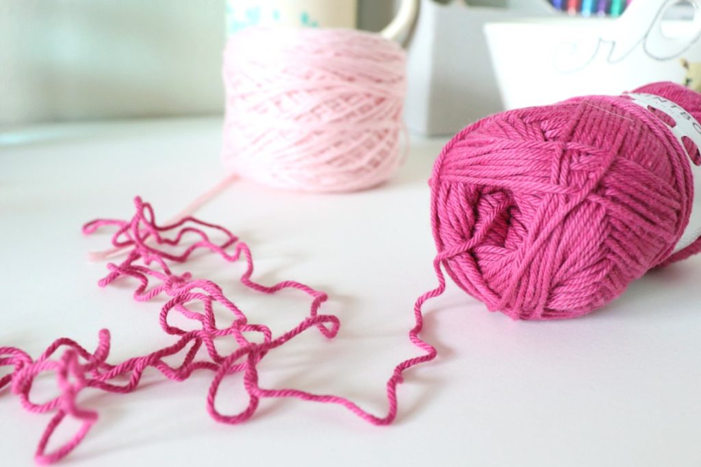 A photo showing how to pull from the center of a skein of yarn rather than using the strand on the outside - via Sigoni Macaroni's latest blog post, 7 Constructive Tips to Improve Your Yarn Tension