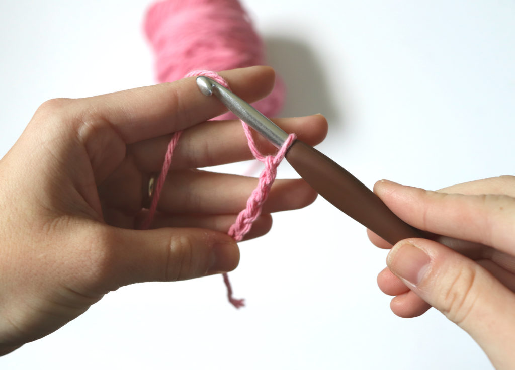 A photo showing how Sigoni holds her crochet hook and yarn in regards to tension - via  her latest blog post, 7 Constructive Tips to Improve Your Yarn Tension