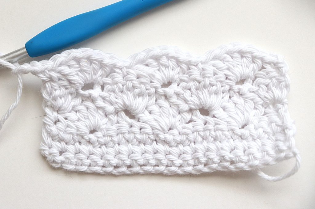 Row 6 of the Basic Shell Stitch Washcloth Crochet Pattern for Beginners - tutorial photo