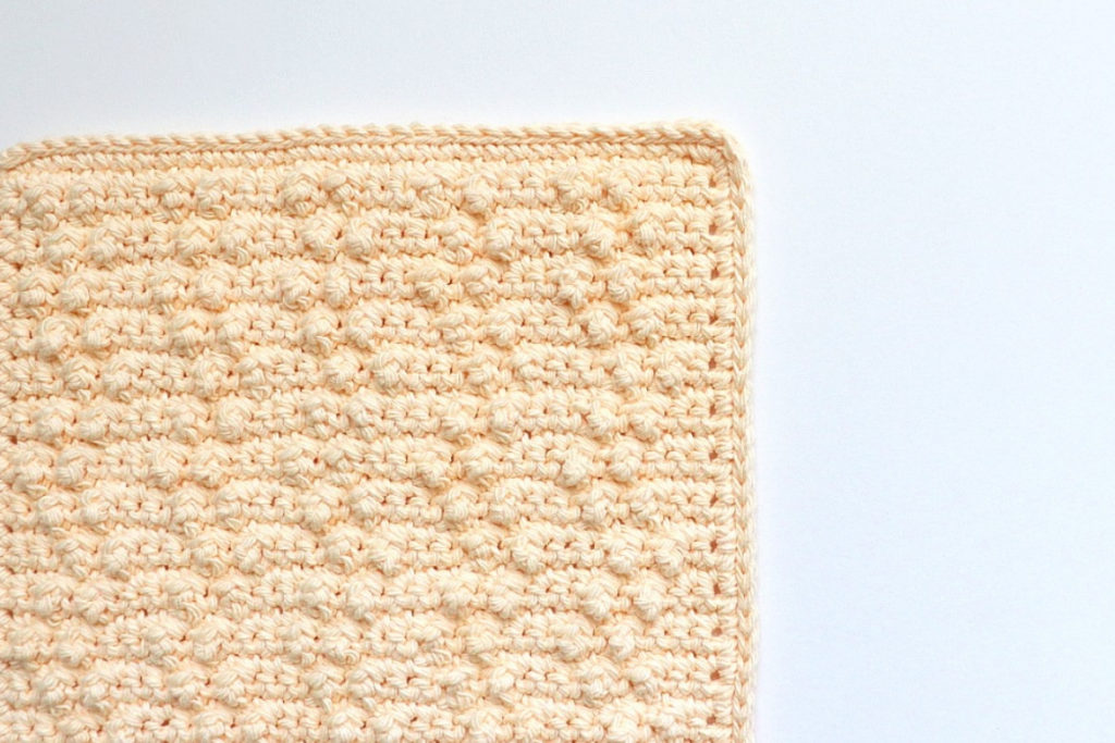 This shows a photo of the treble pop washcloth crochet pattern finished and ready to get to cleaning!