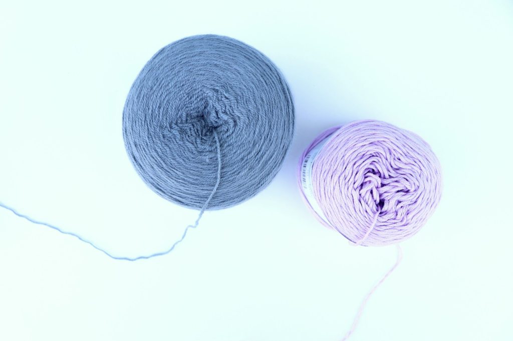 A photo showing what a yarn cake looks like after it is wound up. - via Sigoni Macaroni's How to Choose the Right Yarn for Crochet Beginners