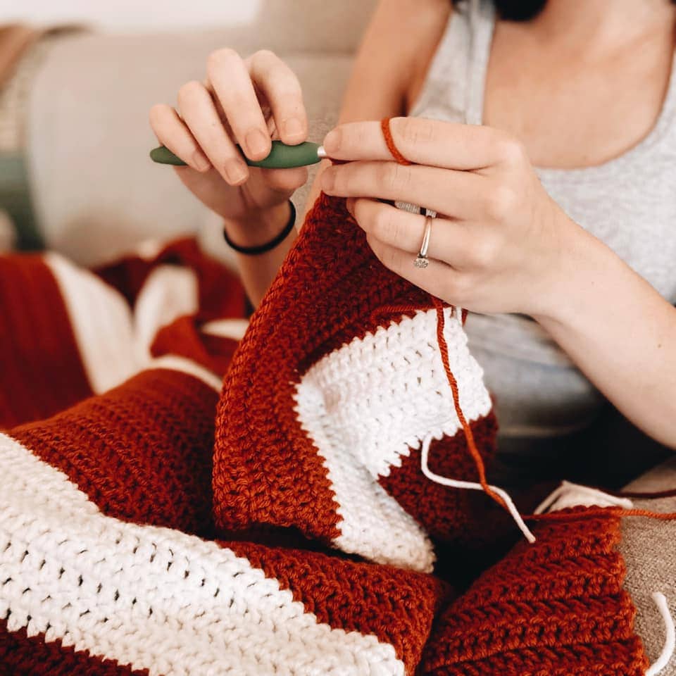 Sigoni crocheting her double crochet blanket in Fall colors