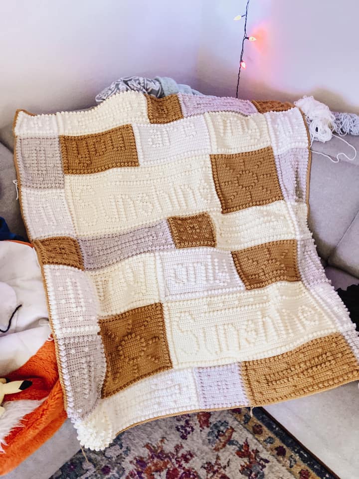 Crochet blanket in neutral colors that reads "You are my sunshine."